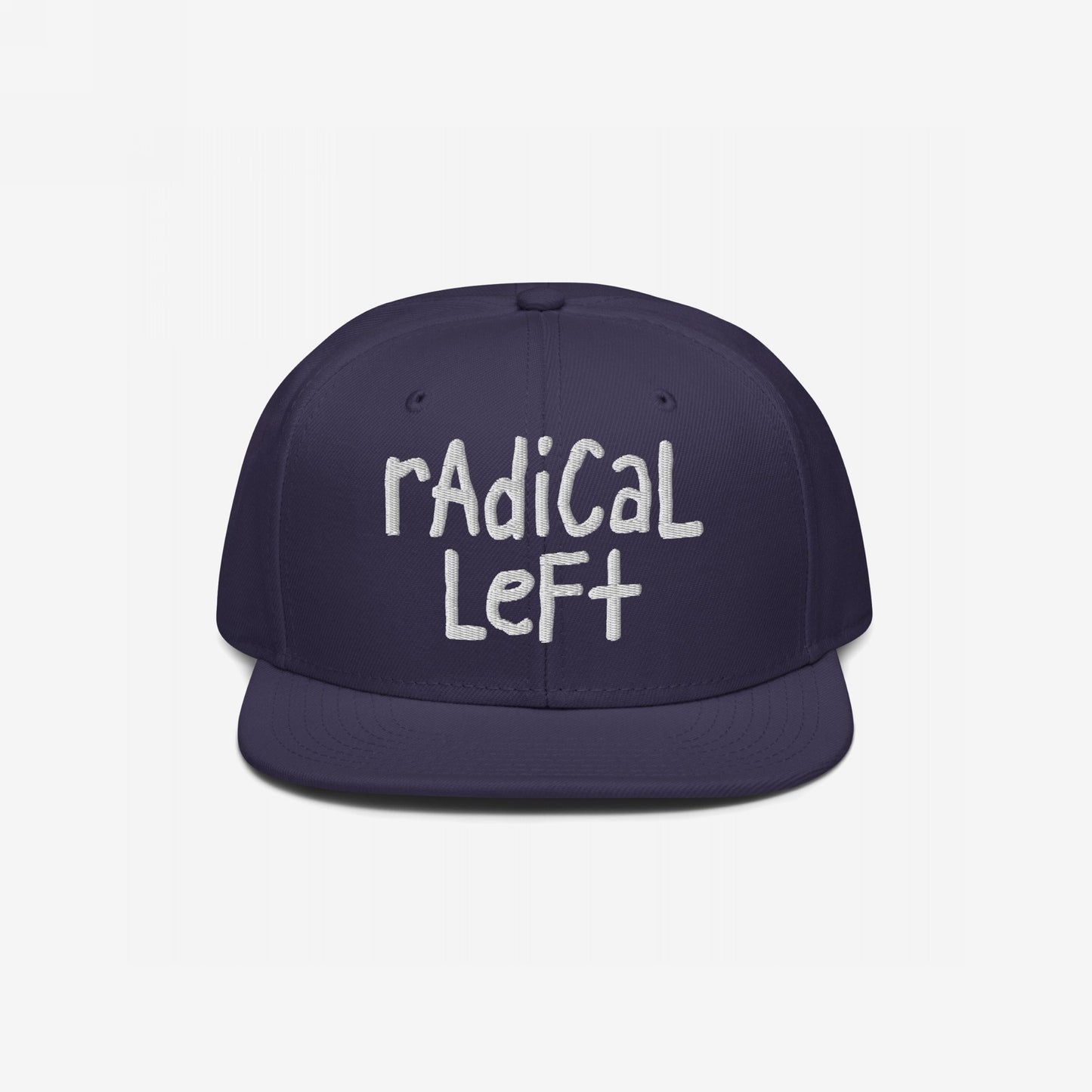 Navy blue Radical Left Hat with radical left in off-white, hand-drawn embroidery. The flat-brimmed cap embodies defiance and progress, challenging norms with a laid-back, bold style.