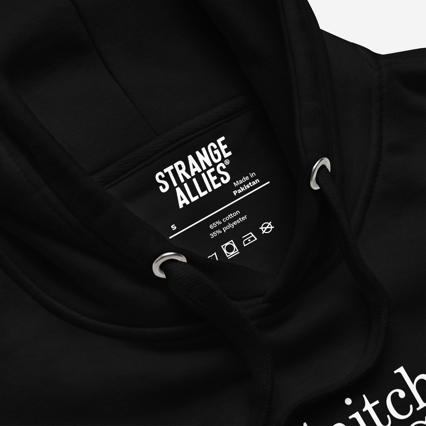 Snitches Get Stitches Hoodie close-up showing the black drawcords, neck label with STRANGE ALLIES®, and a glimpse of the bold white text design, ideal for sarcasm lovers.