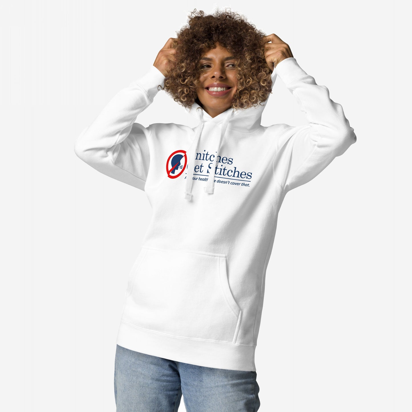 Person with curly hair pulls hood on Snitches Get Stitches Hoodie, featuring a bold red-and-blue logo and humorous tagline, embodying dark humor and social commentary, paired with light-wash jeans.