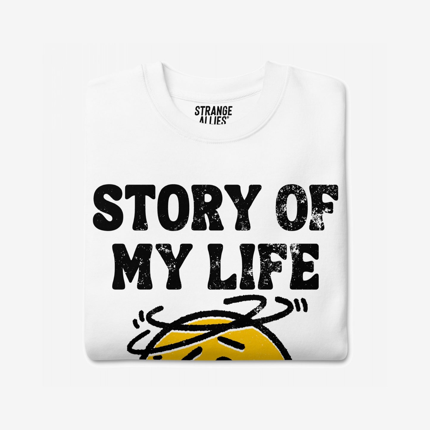 Story Of My Life Sweatshirt features a bold distressed print with a dizzy cartoon face, capturing a relatable theme of life's unpredictability and resilience in style.