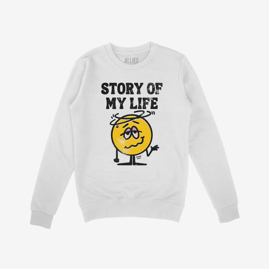Story Of My Life Shirt features a worn block-letter design and a cartoonish, shrugging, dizzy yellow face, embodying life's chaotic mishaps with relatable humor.