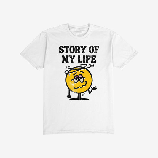 Story Of My Life Shirt featuring a dazed yellow smiley face with swirling lines and droopy eyes, paired with bold distressed lettering, embodying relatable chaos and humor while supporting mental health awareness.