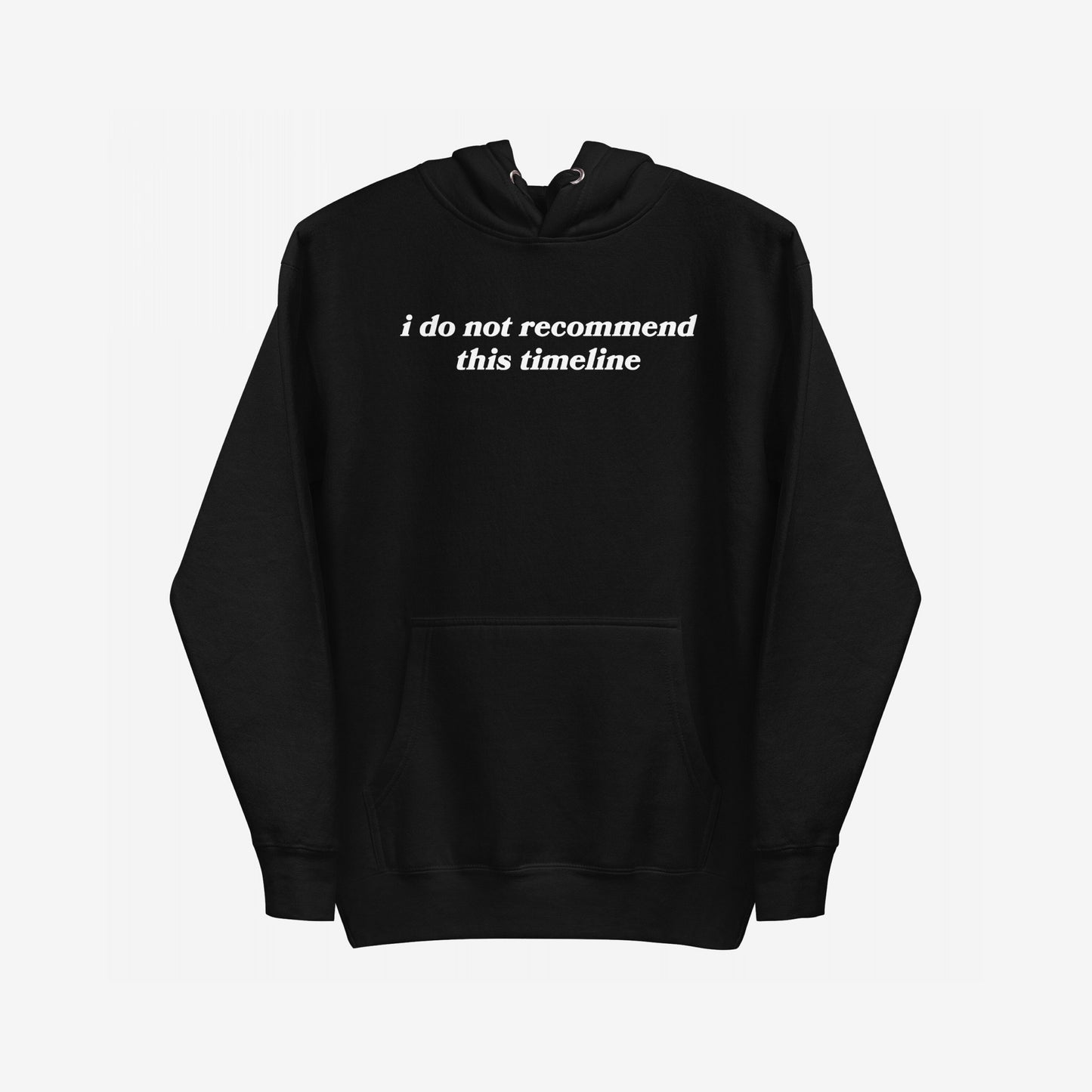 The Timeline Hoodie features a black pullover with I do not recommend this timeline in white serif text across the chest, capturing a sharp, minimalist style with a touch of sarcasm.