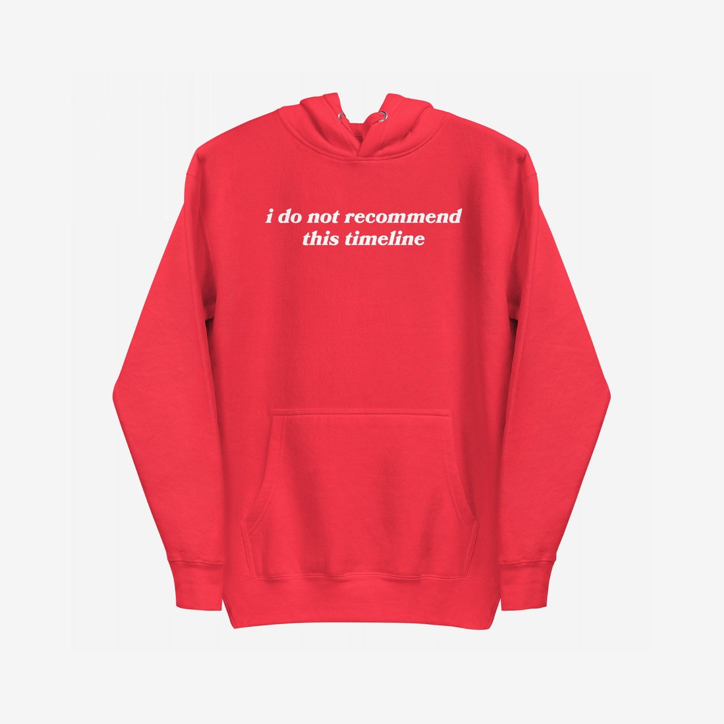 Red pullover hoodie with I do not recommend this timeline in white serif font on chest. The Timeline Hoodie embodies dry wit and dystopian fashion with a kangaroo pocket and drawstring hood.