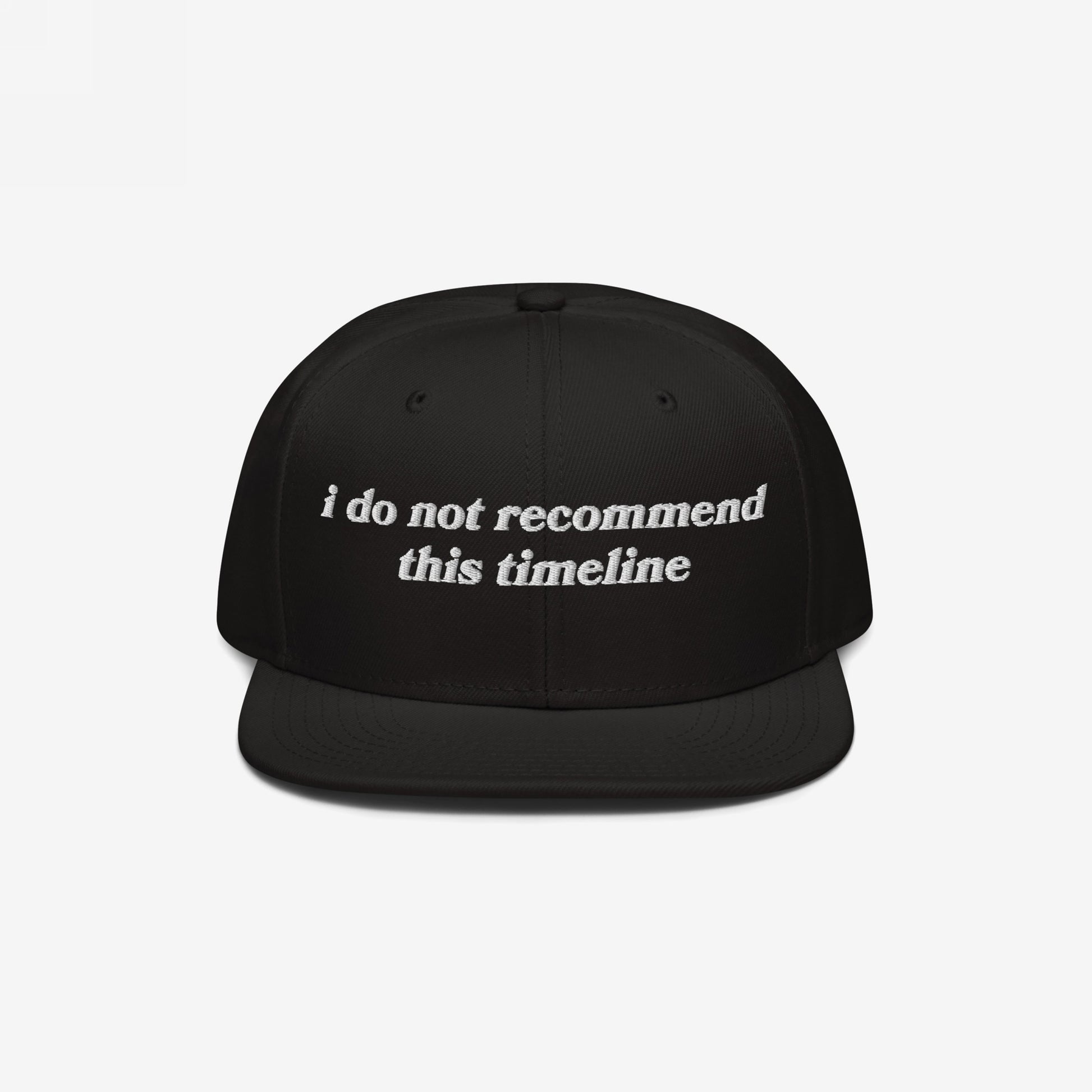 Timeline Hat: Black snapback cap with white embroidery stating, “i do not recommend this timeline.” Perfect for lovers of political humor and irony amidst today's chaos. Supports NAMI.
