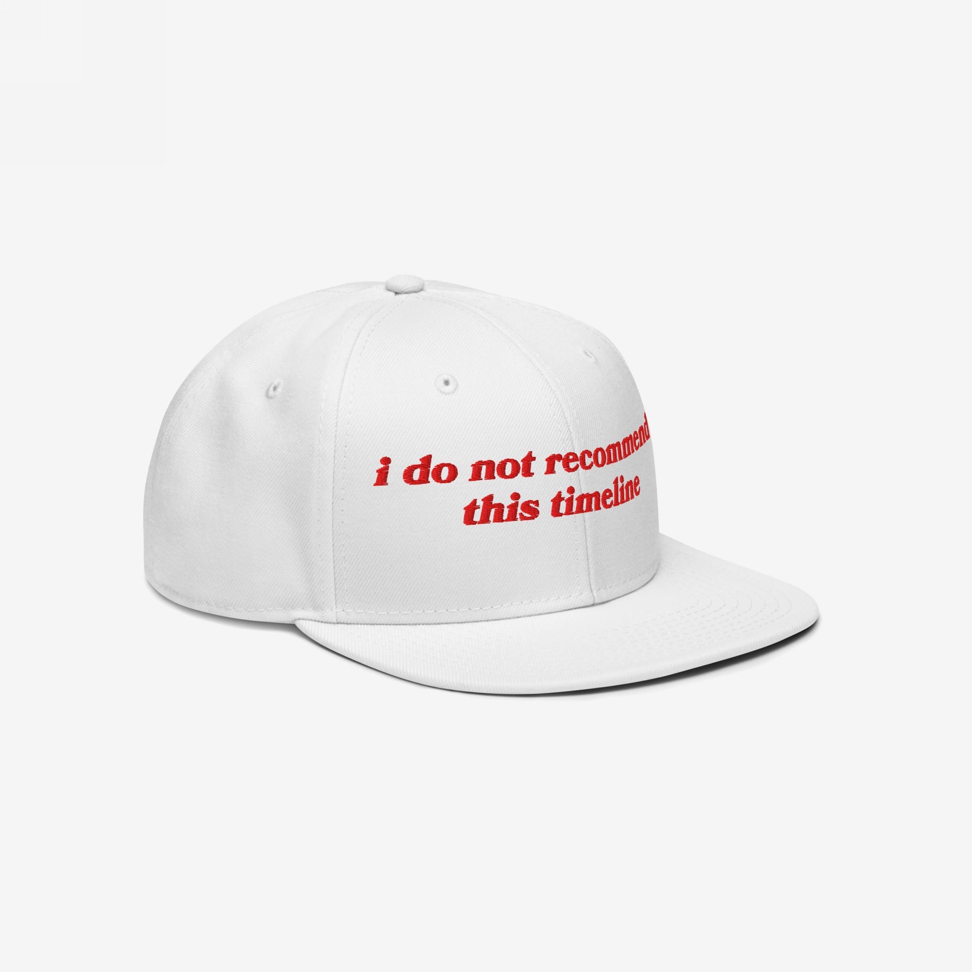 White Timeline Hat with red embroidery: i do not recommend this timeline. A flat-brim snapback cap, embodying sarcastic political humor, ideal for anti-fascists and realists. Donation supports NAMI.