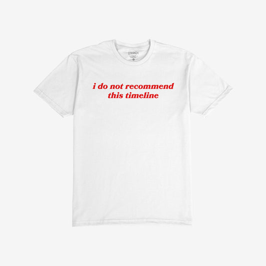 Timeline T-shirt featuring bold red text, i do not recommend this timeline, captures a sarcastic take on modern discontent. Back collar label visible. Available in various fits and sizes.
