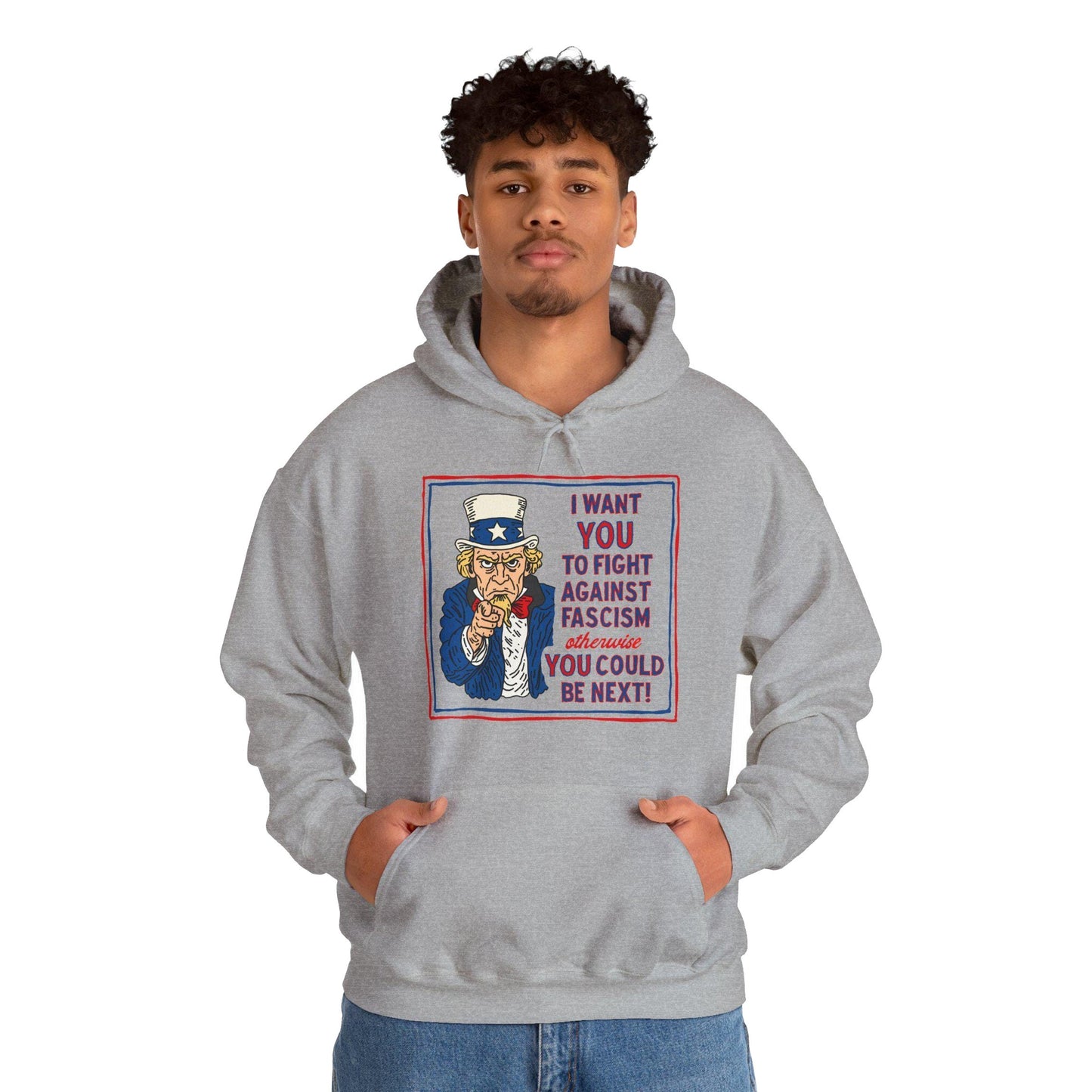 Man wearing black Anti-Fascist Uncle Sam Hoodie, featuring bold Uncle Sam artwork and text urging action against fascism. The design is part of a collection promoting equality and resistance.