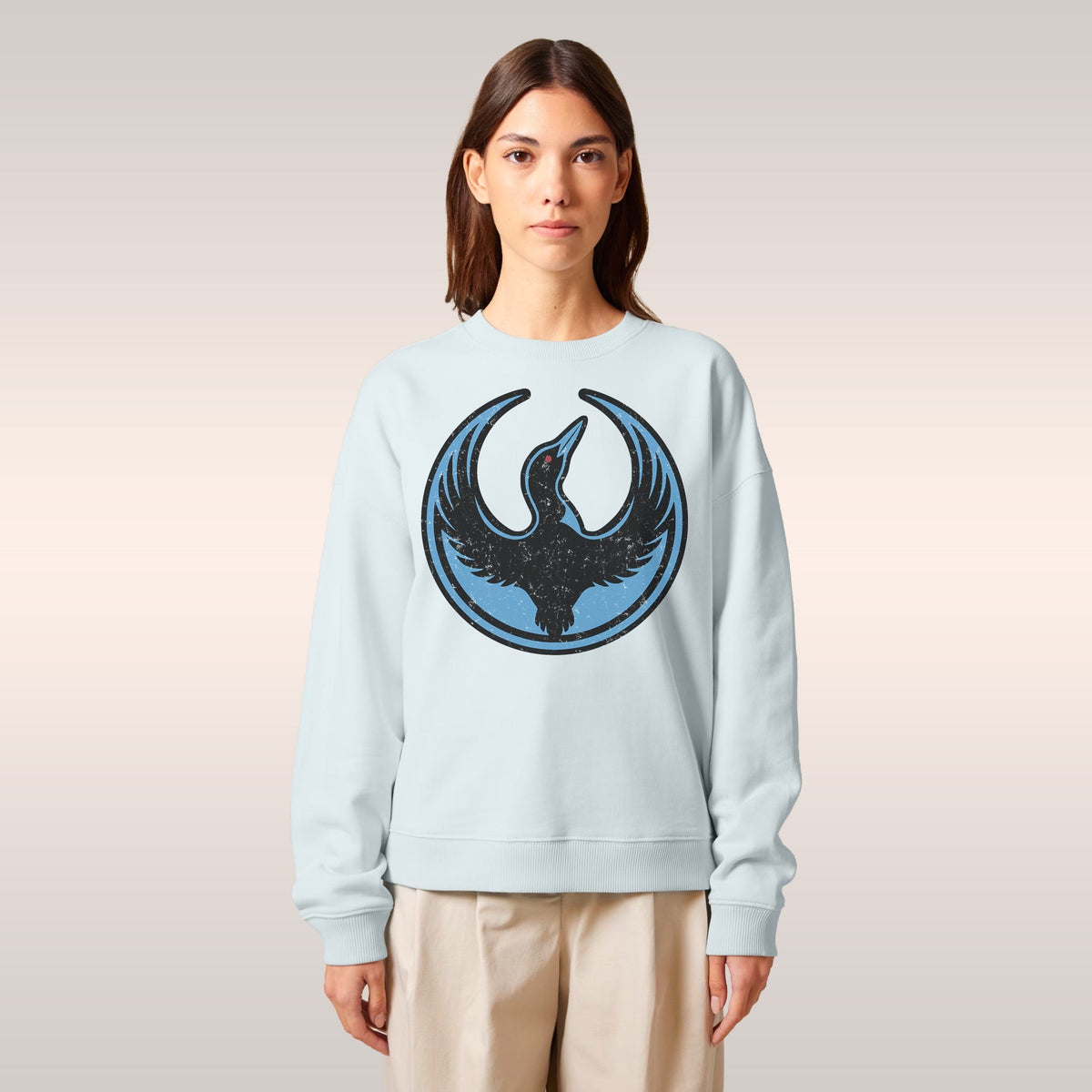 Model wearing the Minnesota Rebel Alliance Hoodie & Sweatshirt, featuring a black loon emblem on pale blue. Styled with a bla