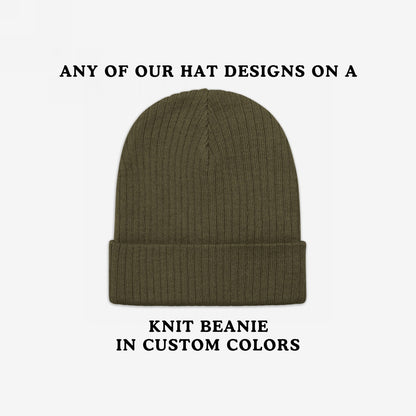 Knit Beanie In Custom Colors showcasing its olive-green hue and folded cuff on a white backdrop, embodying bold political and anti-fascist designs with customizable colors for personalized, statement-making wear.