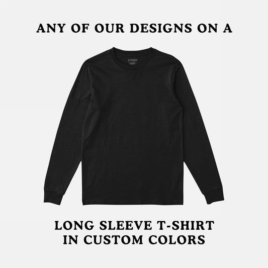 Black Long Sleeve T-shirt In Custom Colors displayed against a light gray background, featuring small bold lettering for customization details. Inside, a label is visible at the neckline.