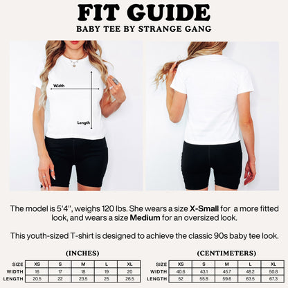 Watch List Women's Baby Tee fit guide, showcasing a model wearing a white crop tee with sizing details for XS to XL, capturing the rebellious, 90s-inspired, feminist style.