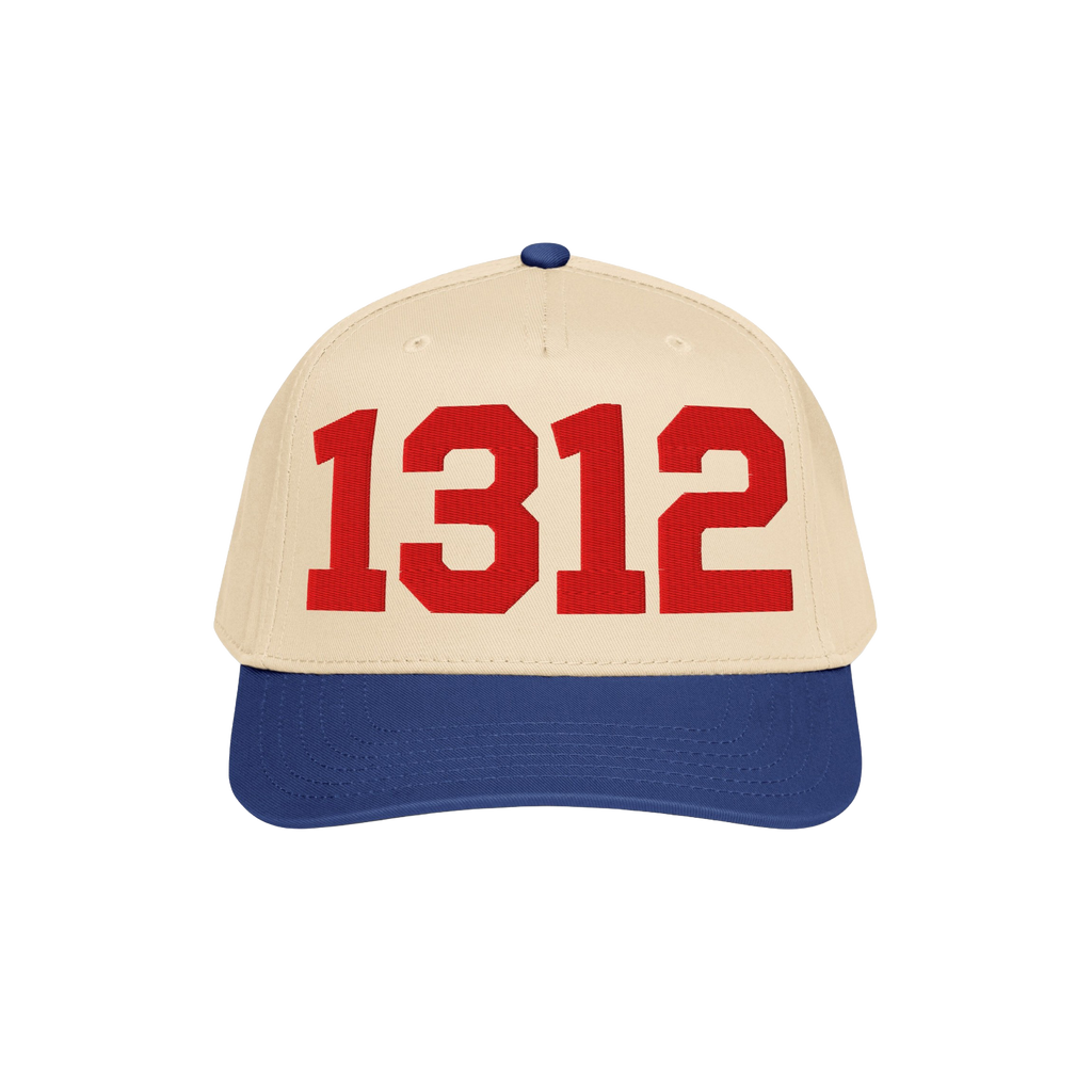 Two-tone 1312 ACAB Hat with a light beige crown and royal blue brim, featuring bold red 1312 numerals on the front panel, sym