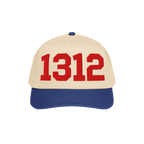 Two-tone 1312 ACAB Hat with a light beige crown and royal blue brim, featuring bold red 1312 numerals on the front panel, sym