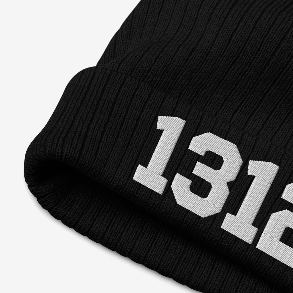 Black rib-knit beanie with bold white 1312 on cuff, known as the 1312 ACAB Hat, symbolizing protest against police brutality; a statement piece for those advocating accountability.