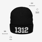 1312 ACAB Hat: A black knit beanie featuring 1312 in white embroidery on the cuff. It has a narrow rib-knit texture, double-layered for warmth, made from recycled polyester.