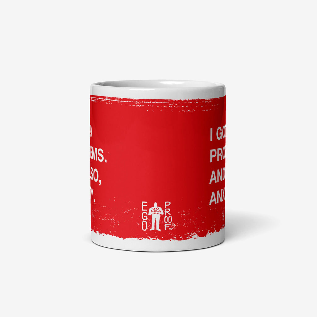 99 Problems Mug with a distressed red band and bold slogan, I got 99 problems. And also, anxiety. Features a small Ego Proof logo, embodying humor and solidarity for everyday challenges.