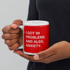 Close-up of a person holding the 99 Problems Mug, featuring a bold red panel with I GOT 99 PROBLEMS. AND ALSO, ANXIETY. in white text, capturing a blend of humor and solidarity.