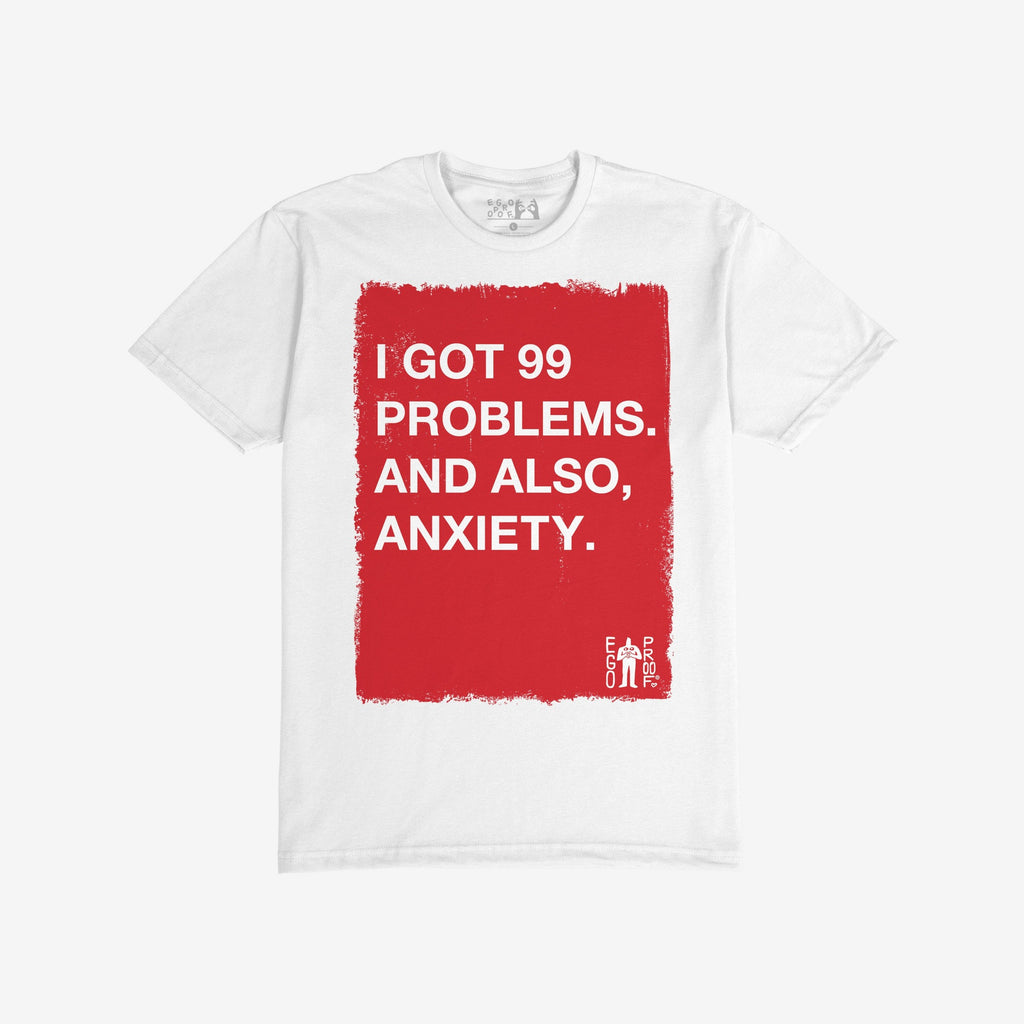 White T-shirt titled 99 Problems T-shirt features a bold red rectangle with white text stating, “I GOT 99 PROBLEMS. AND ALSO, ANXIETY.” A small EGO PROF. logo appears in the corner.