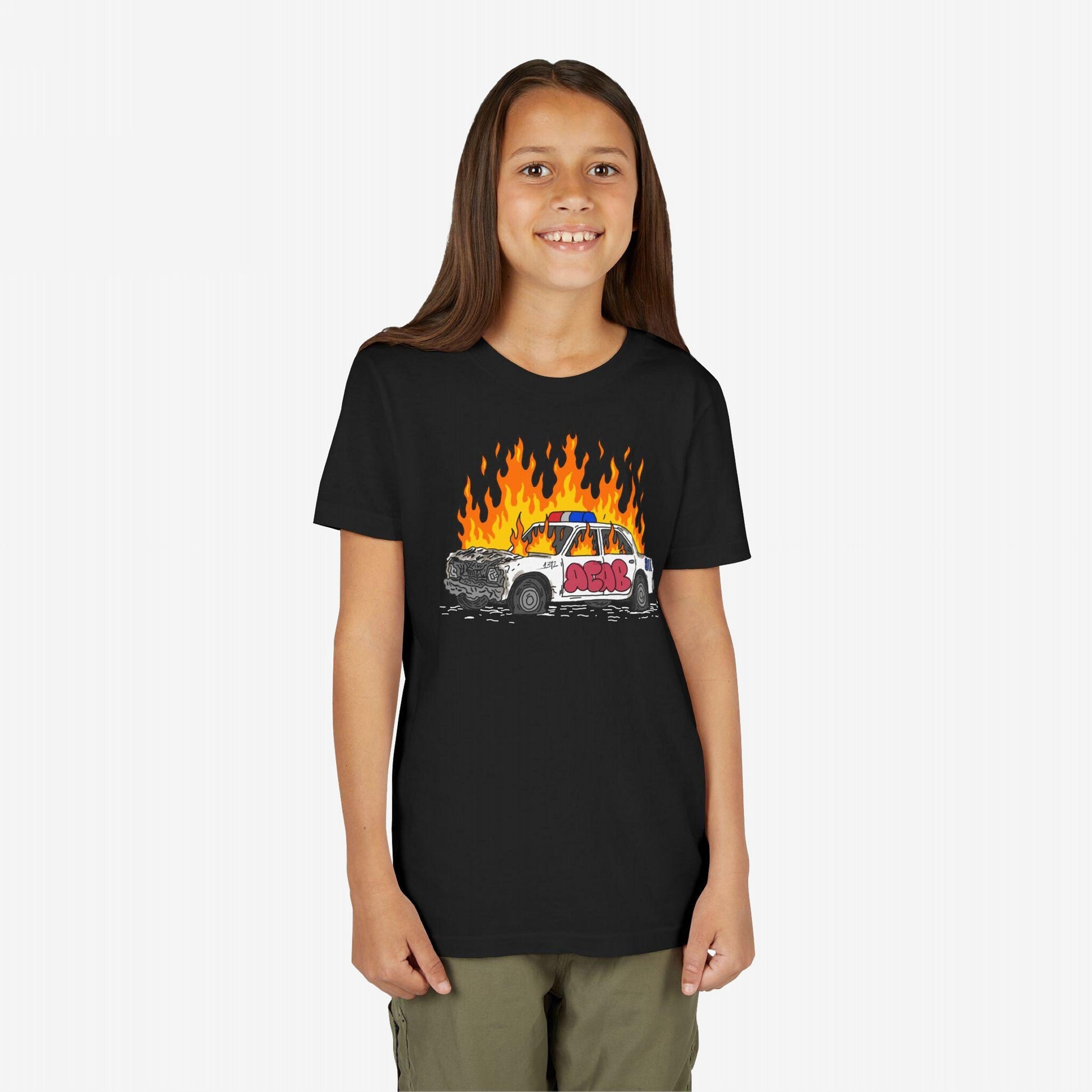 Child wearing ACAB Police Car T-shirt with flaming police cruiser graphic, expressing defiance and bold values. Perfect for those embodying unapologetic edge and speaking truth to power.