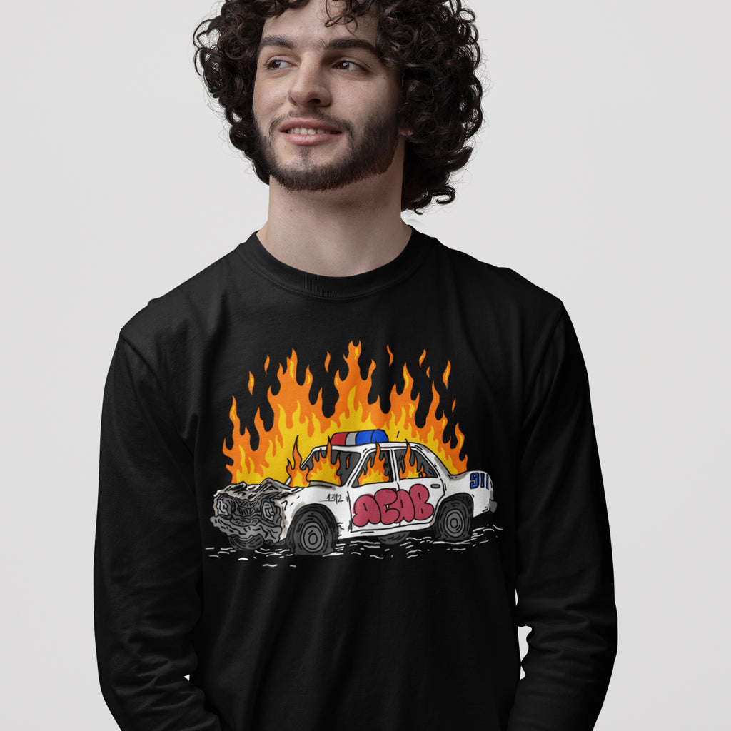 Man wearing black long sleeve ACAB Police Car Shirt with burning police car graphic and graffiti 1312 design.