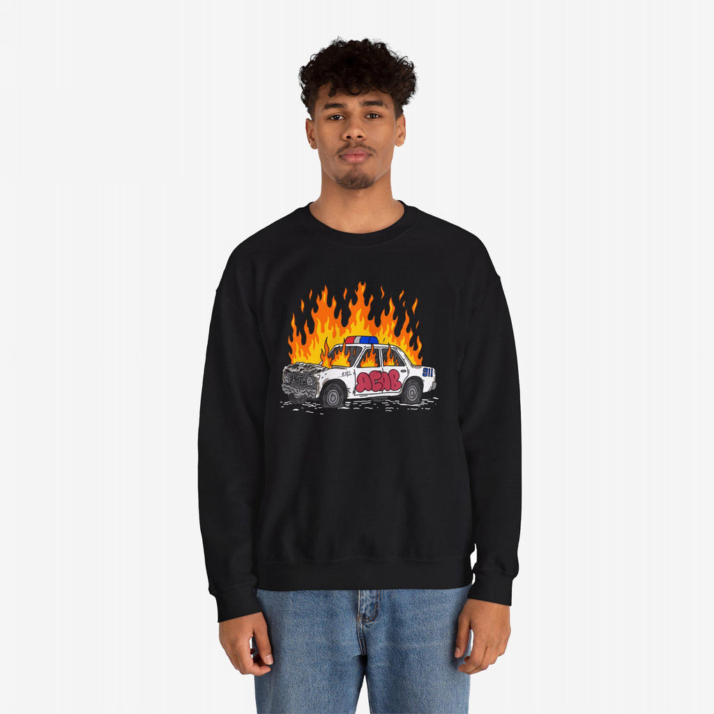 Man wearing black sweatshirt with ACAB Police Car Shirt design of flaming police car and graffiti 1312 text.