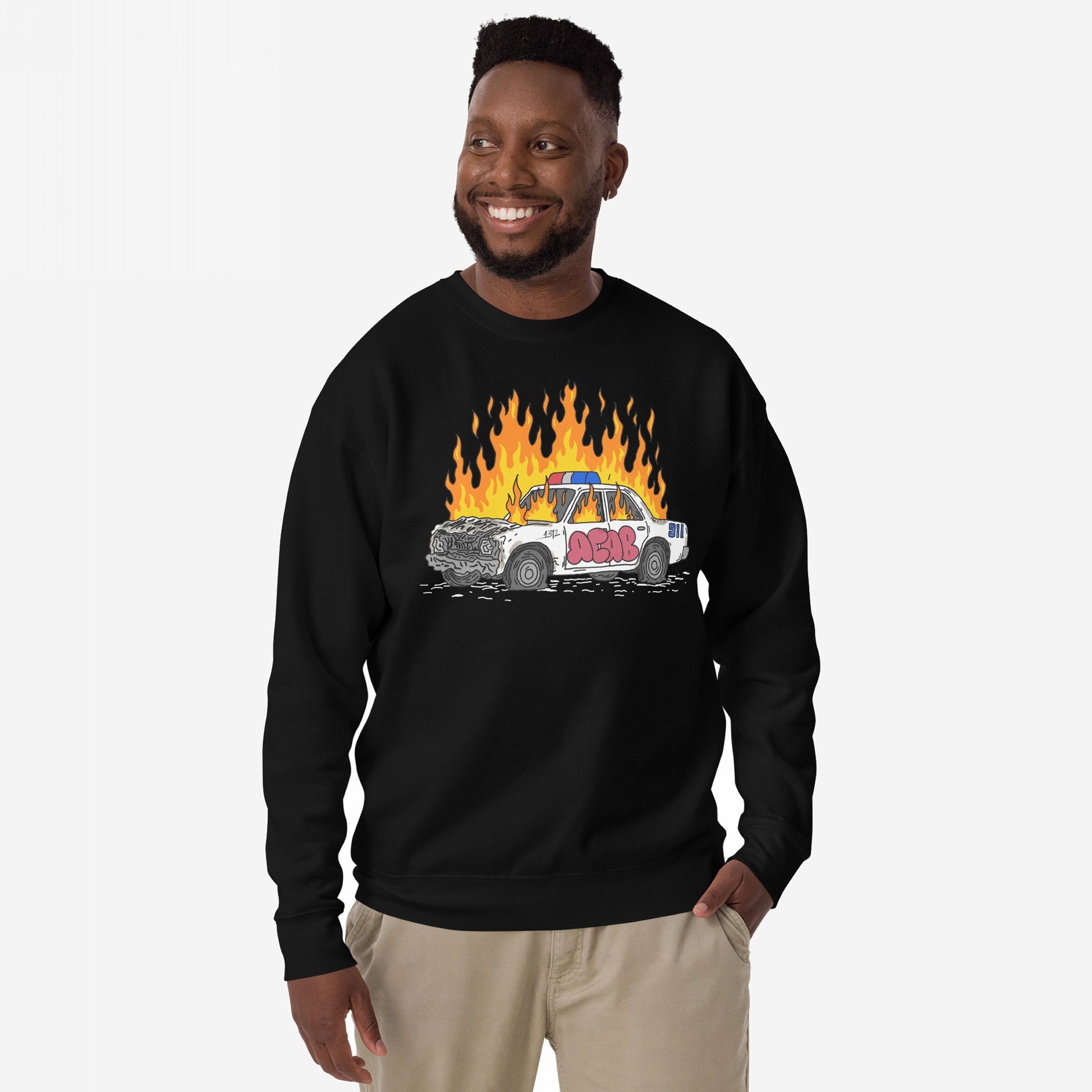 ACAB Police Car Hoodie & Sweatshirt features a bold design with a cartoon wrecked police cruiser in flames, tagged with graffiti, embodying rebellious, punk energy and visible resistance.
