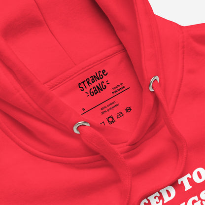 Close-up of the Addicted To Love / Drugs Hoodie, featuring STRANGE GANG label, size S, red drawstrings through metal grommets, and partial white graphic suggesting bold, thought-provoking design.