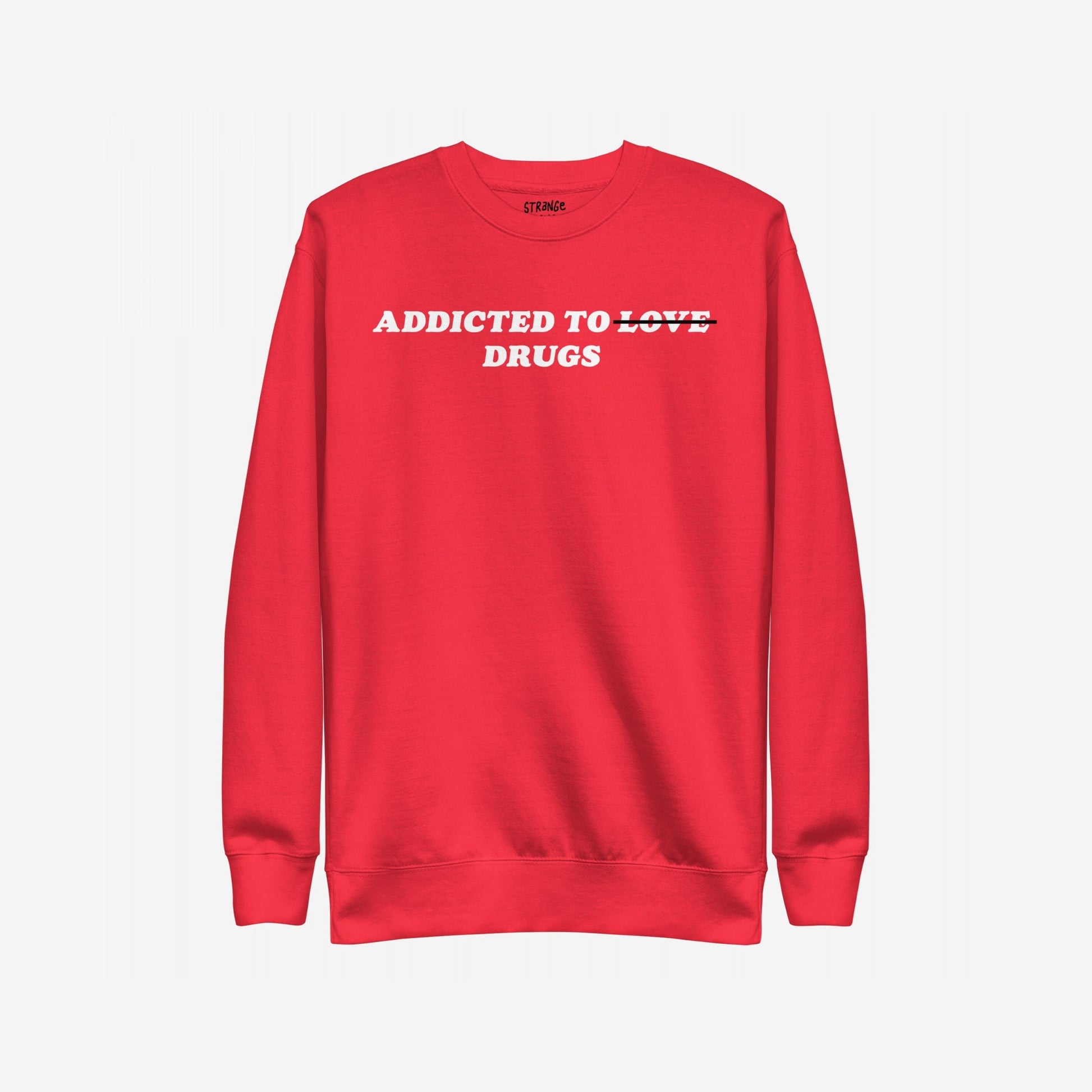 Addicted To Love / Drugs Hoodie & Sweatshirt features bold white text with 'LOVE' crossed out, replaced by 'DRUGS', capturing themes of personal struggle and self-awareness on a bright red crewneck.