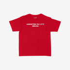 Addicted To Love / Drugs Women's Baby Tee featuring bold white text with LOVE struck-through and replaced by DRUGS, capturing chaotic humor and honesty on a plain red crew-neck style.
