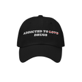 Black embroidered Addicted To Love / Drugs Hat with "Love" crossed out and replaced by "Drugs" in bold text on front.