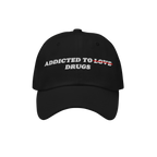 Black embroidered Addicted To Love / Drugs Hat with "Love" crossed out and replaced by "Drugs" in bold text on front.