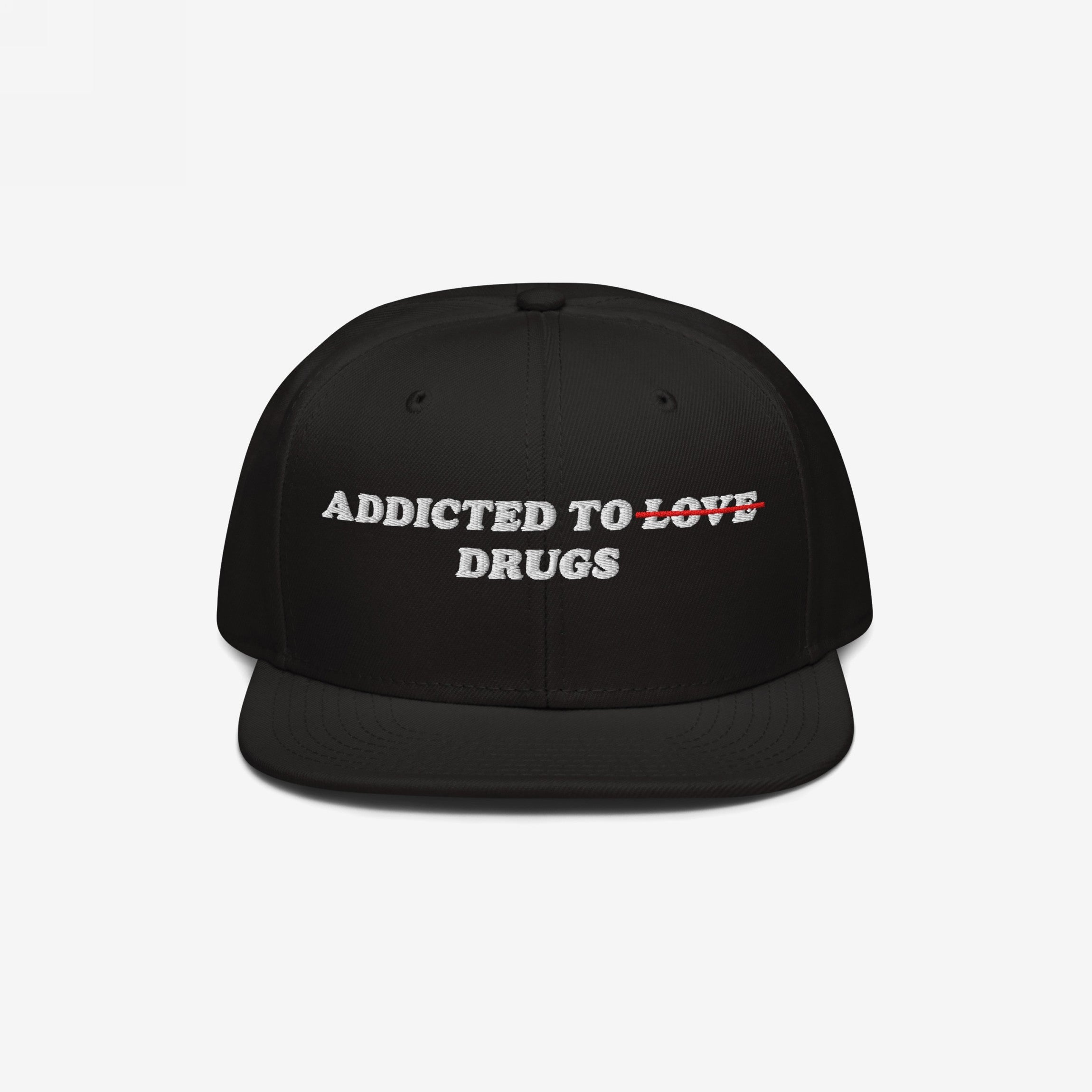 Black snapback hat with embroidered text "Addicted To Love" crossed out and replaced by "Drugs" on the Addicted To Love / Drugs Hat.