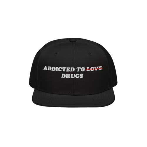 Black snapback hat with embroidered text "Addicted To Love" crossed out and replaced by "Drugs" on the Addicted To Love / Dru