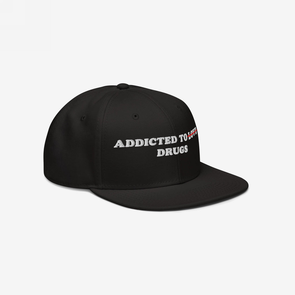 Black snapback hat with embroidered "Addicted To Love" crossed out and replaced by "Drugs," titled Addicted To Love / Drugs Hat.