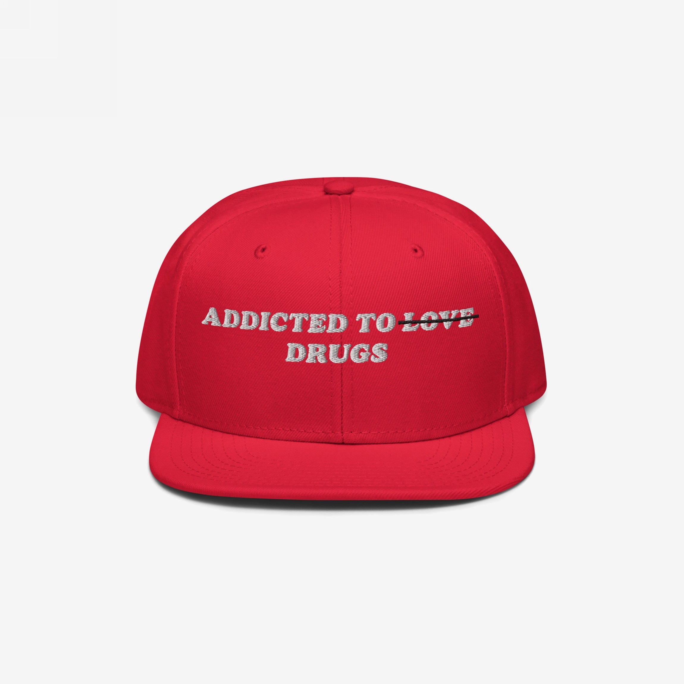 Red snapback hat with embroidered "Addicted To Love" crossed out and replaced by "Drugs" text, titled Addicted To Love / Drugs Hat.