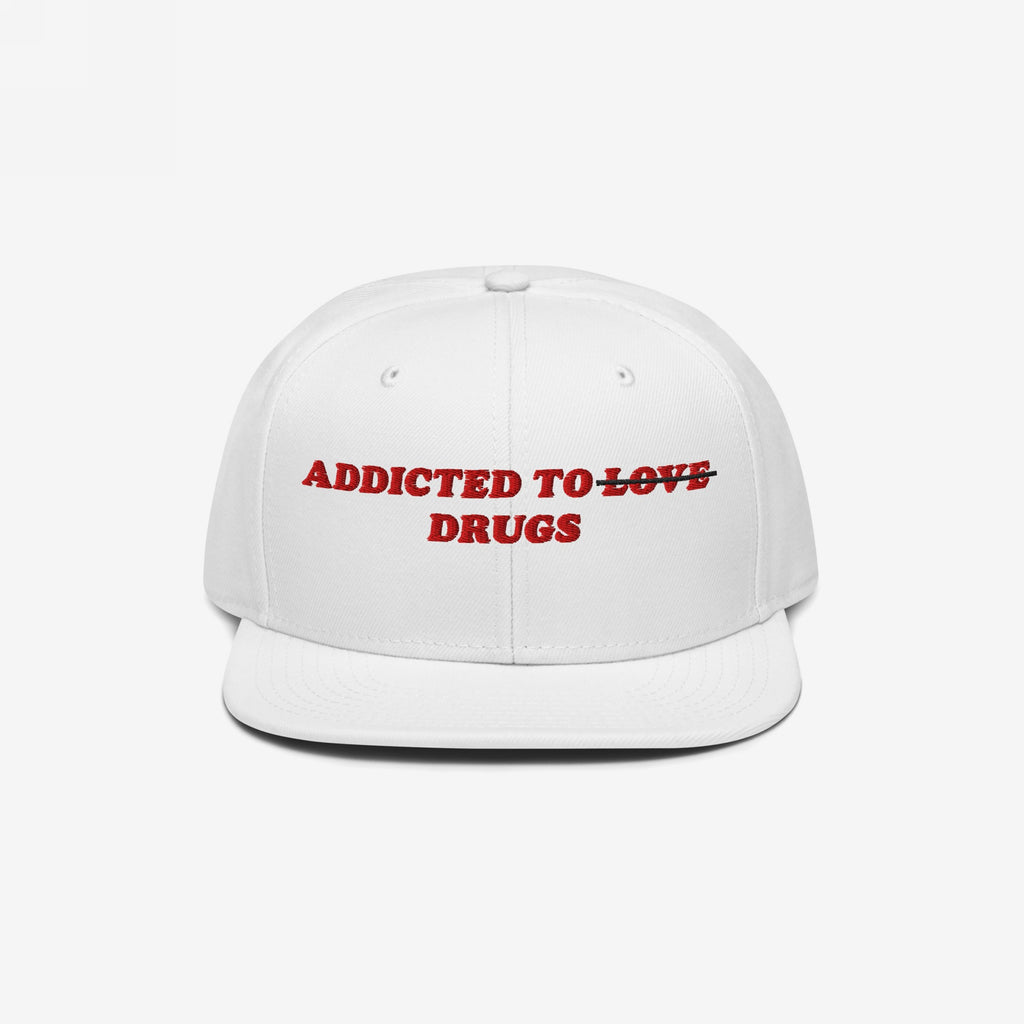 White snapback hat with red embroidered text "Addicted to ~Love~ Drugs" front design, titled Addicted To Love / Drugs Hat.