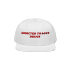 White snapback hat with red embroidered text "Addicted to ~Love~ Drugs" front design, titled Addicted To Love / Drugs Hat.