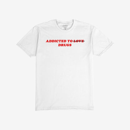 Addicted To Love / Drugs T-shirt featuring bold red text with LOVE crossed out, highlighting DRUGS beneath, encapsulates a provocative, unapologetic statement.