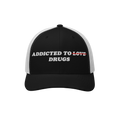 Black and white snapback hat with embroidered text "Addicted to Drugs" crossing out "Love," called Addicted To Love / Drugs H