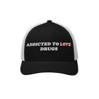 Black and white snapback hat with embroidered text "Addicted to Drugs" crossing out "Love," called Addicted To Love / Drugs H