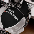 Black and white snapback hat with embroidered text "Addicted To Love" crossed out and replaced by "Drugs," titled Addicted To Love / Drugs Hat.