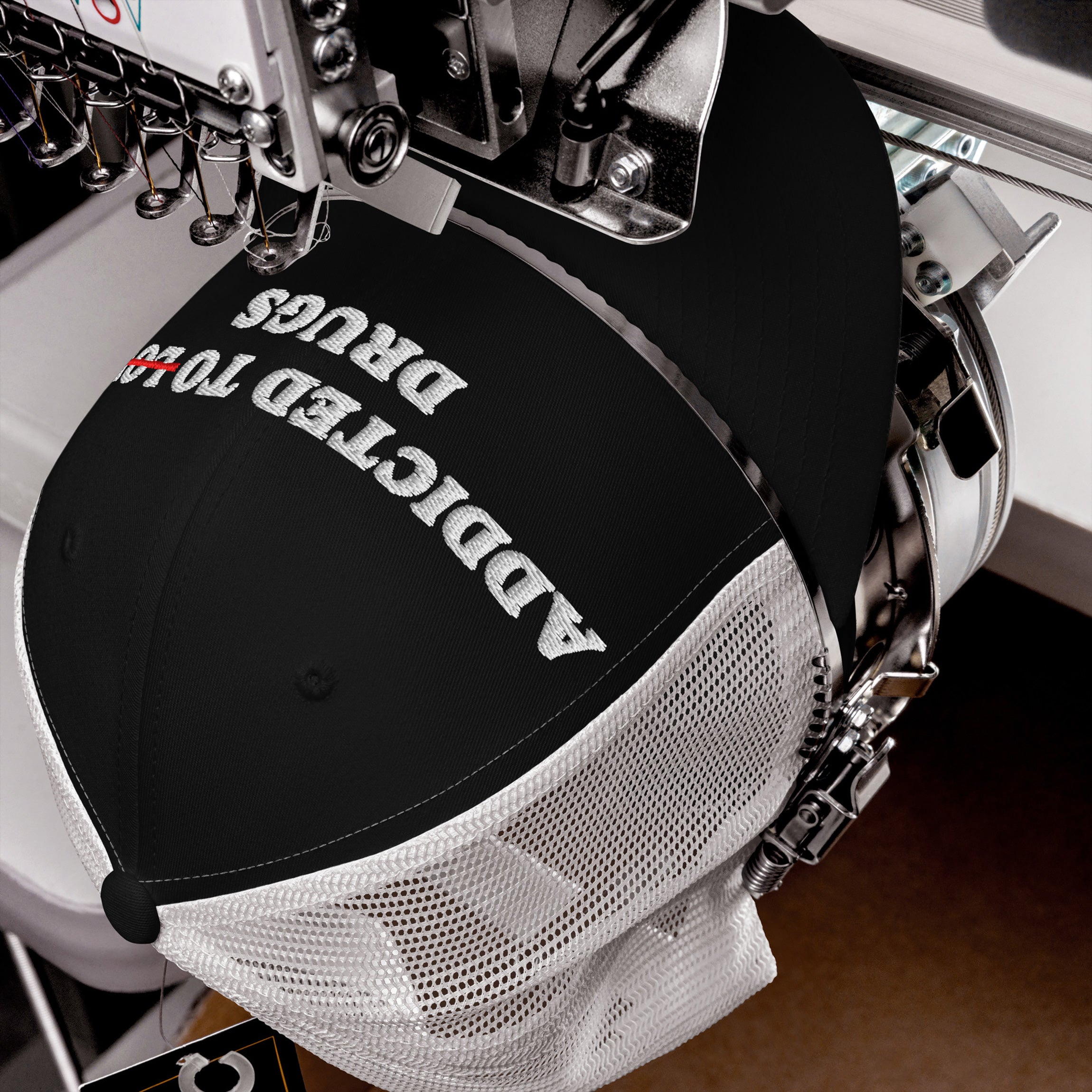 Black and white snapback hat with embroidered text "Addicted To Love" crossed out and replaced by "Drugs," titled Addicted To Love / Drugs Hat.