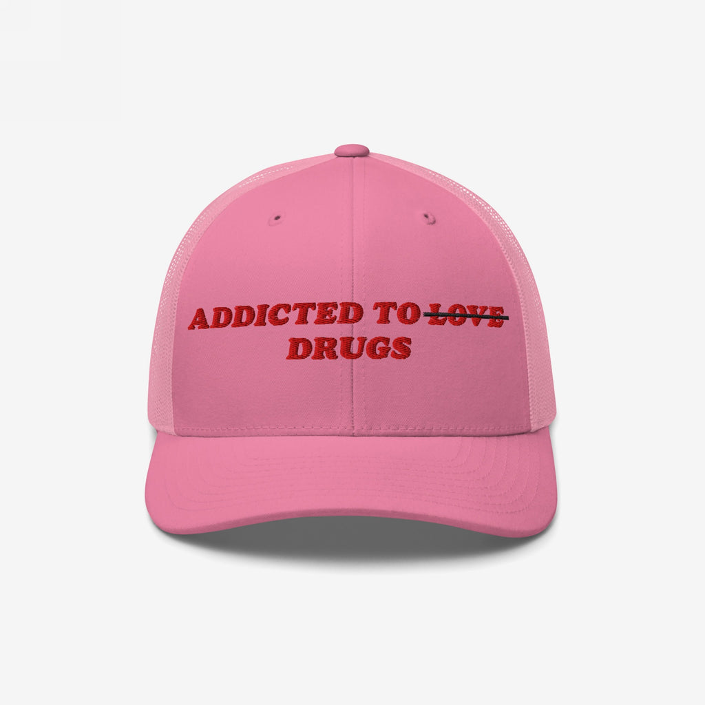 Pink snapback hat with embroidered text "Addicted To Love" crossed out and replaced by "Drugs" from the Addicted To Love / Drugs Hat collection.