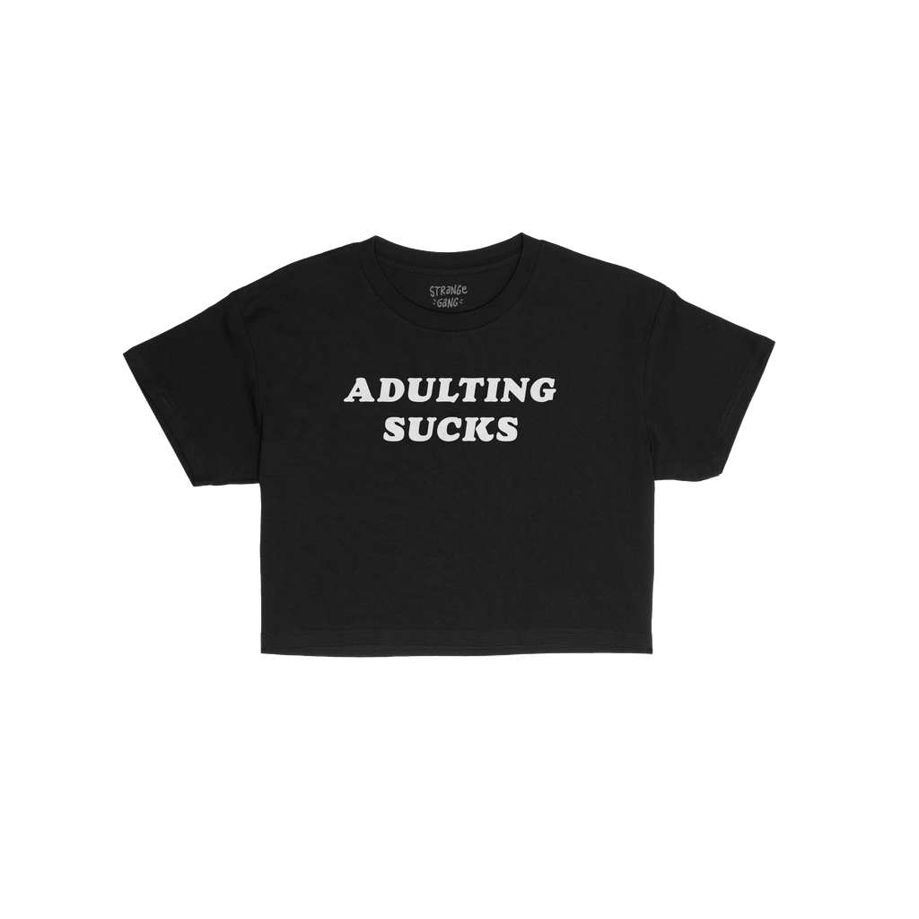 Adulting Sucks Women's Baby Tee features bold white text on a black cropped shirt, expressing relatable humor for life's chal