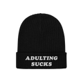 Adulting Sucks Hat: Black rib-knit beanie with ADULTING SUCKS embroidered in white on the brim, reflecting a bold, relatable 