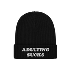 Adulting Sucks Hat: Black rib-knit beanie with ADULTING SUCKS embroidered in white on the brim, reflecting a bold, relatable 