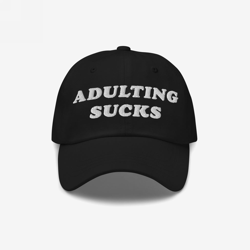 Black cap with “ADULTING SUCKS” embroidered in white, capturing a relatable sentiment for millennials and professionals. Perfect for expressing frustration with adult responsibilities.