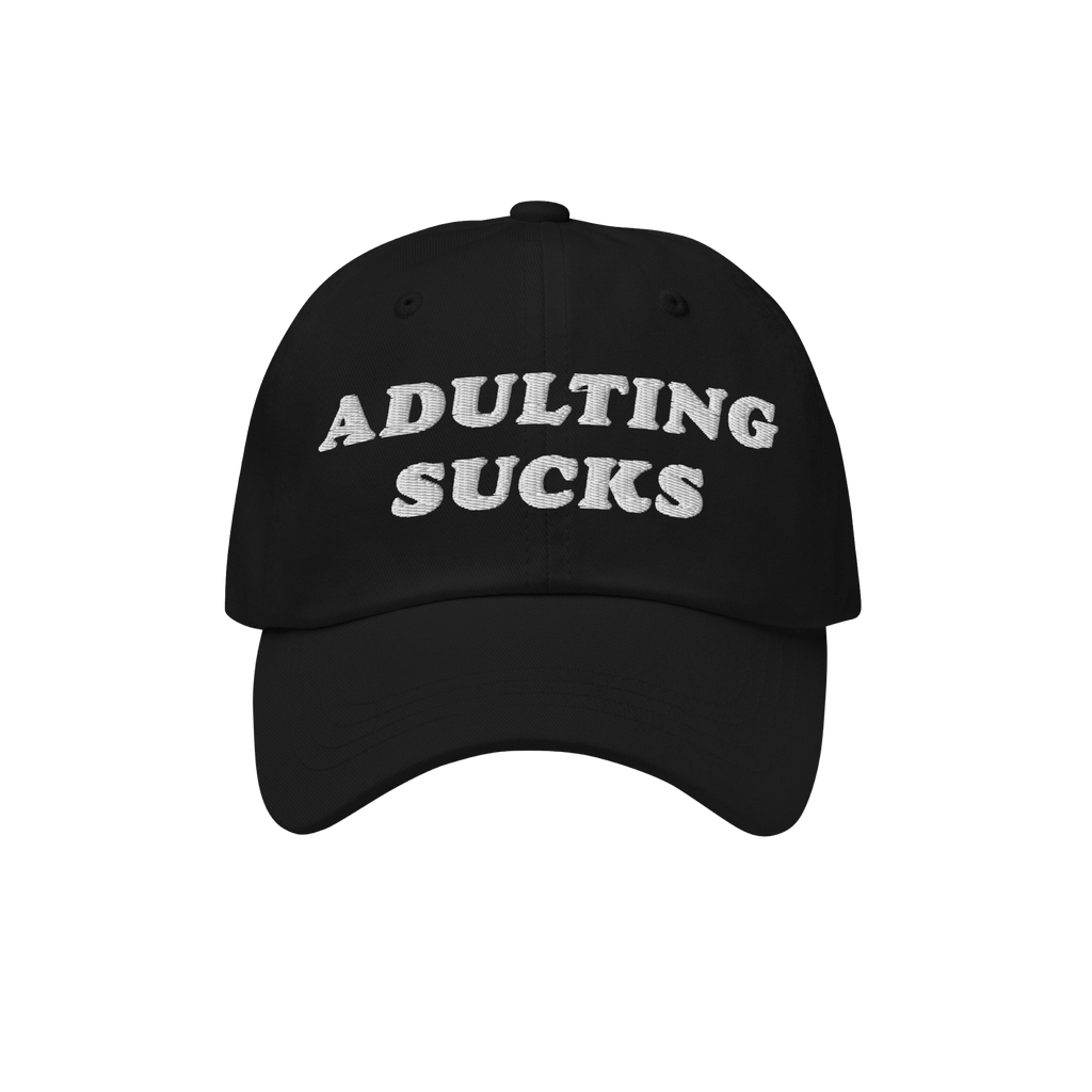 Black cap with “ADULTING SUCKS” embroidered in white, capturing a relatable sentiment for millennials and professionals. 