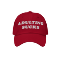Red baseball cap with ADULTING SUCKS embroidered in bold white letters, capturing a vintage-inspired style perfect for expres